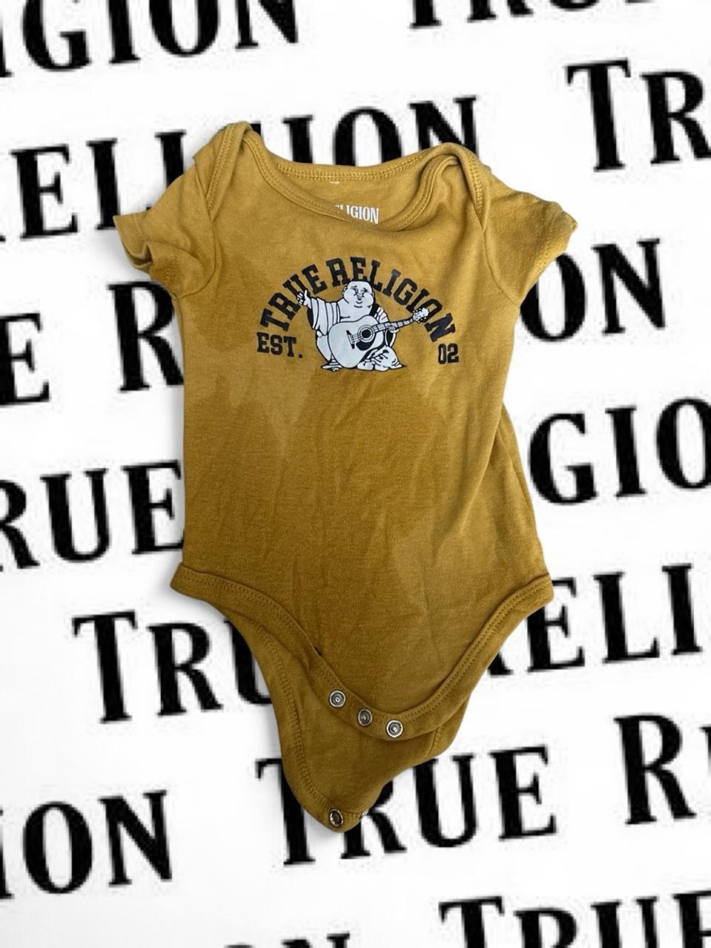 True Religion Mustard Baby Bodysuit with Guitar Buddha Graphic